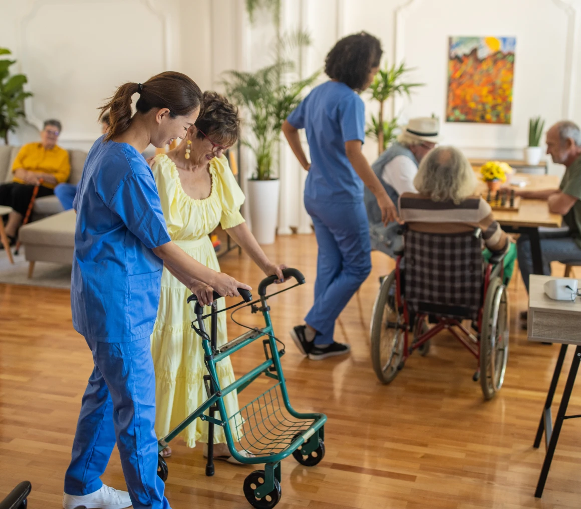 Care home staff helping residents