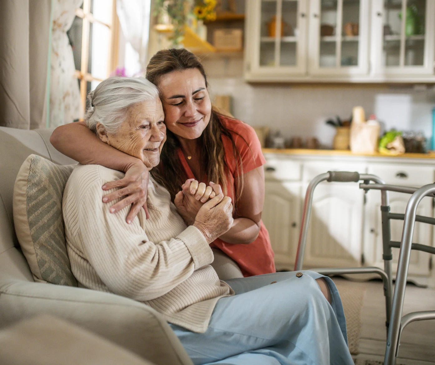 Elderly woman and young woman embracing
